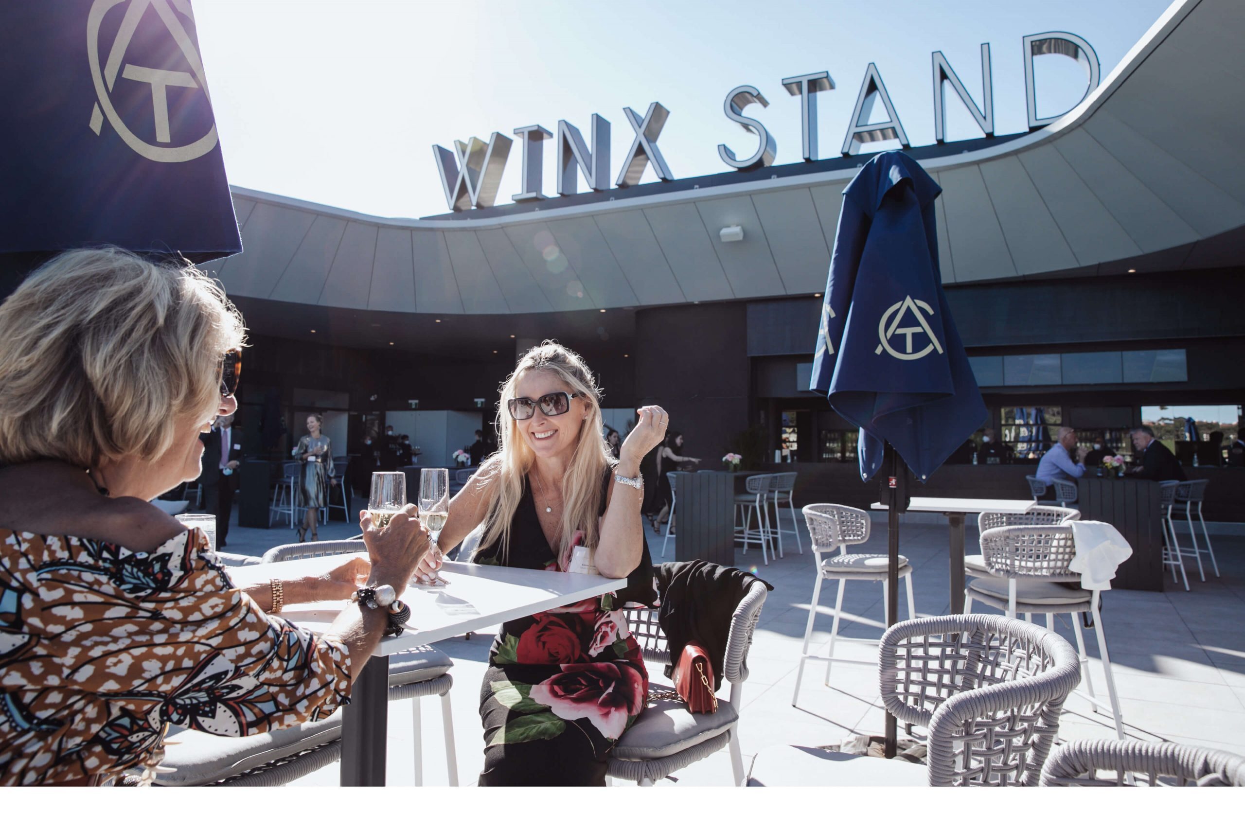 001 ladies enjoying a drink on the winx stand taylor