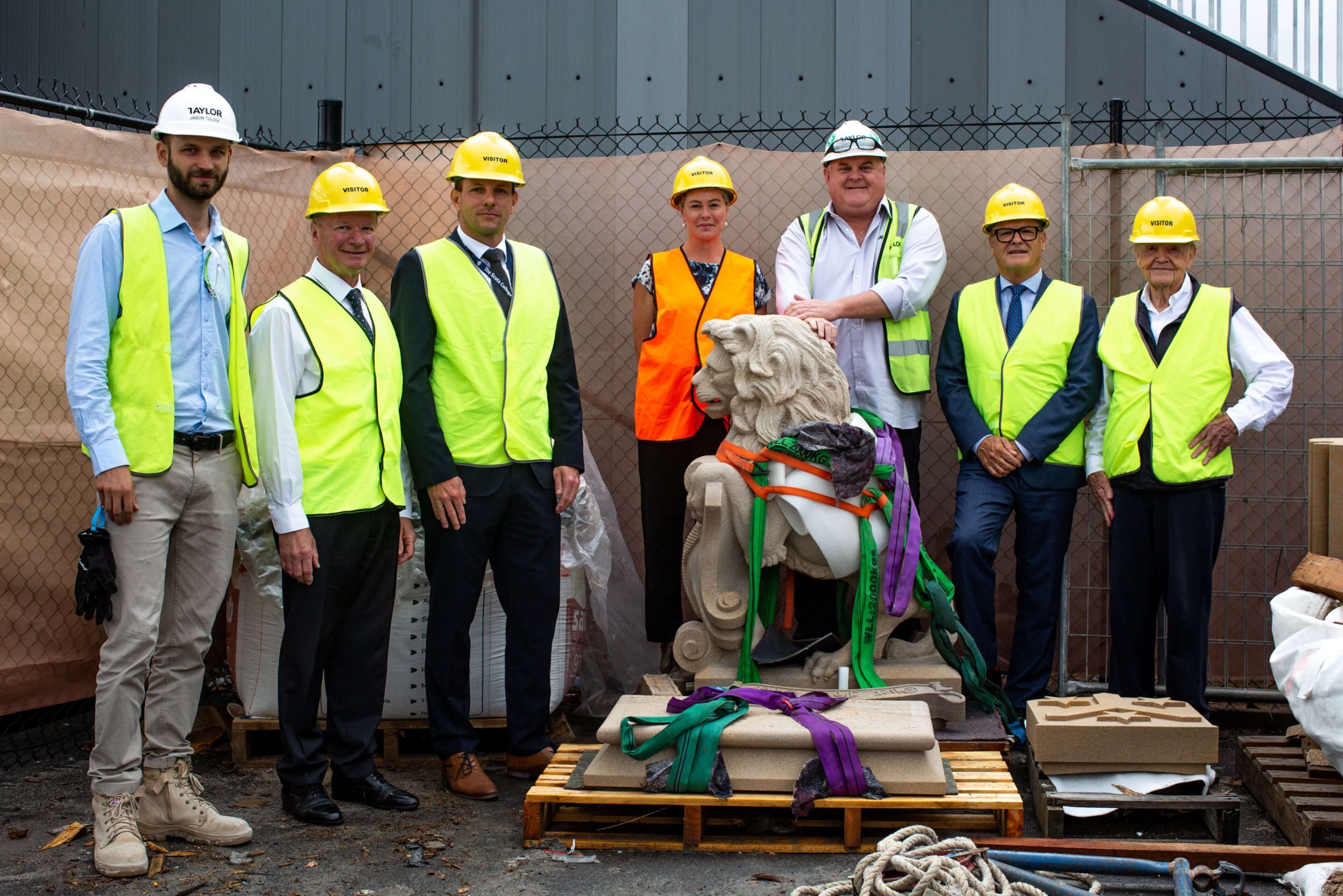 002 project team pose with special guests around lion ornament prior to installation taylor refurbishment and live environments