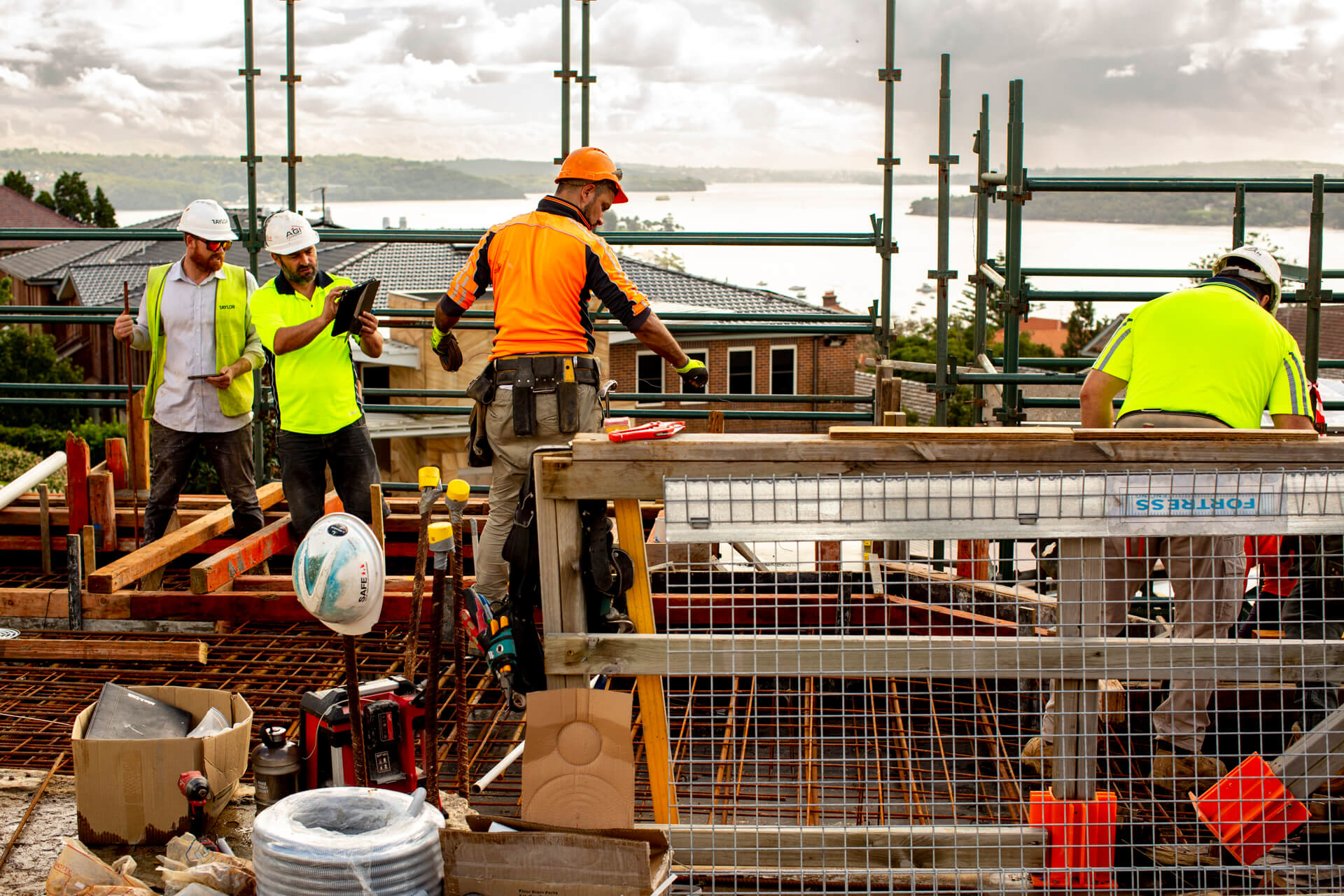004 workers on scaffolding against ocean backdrop taylor scots college school