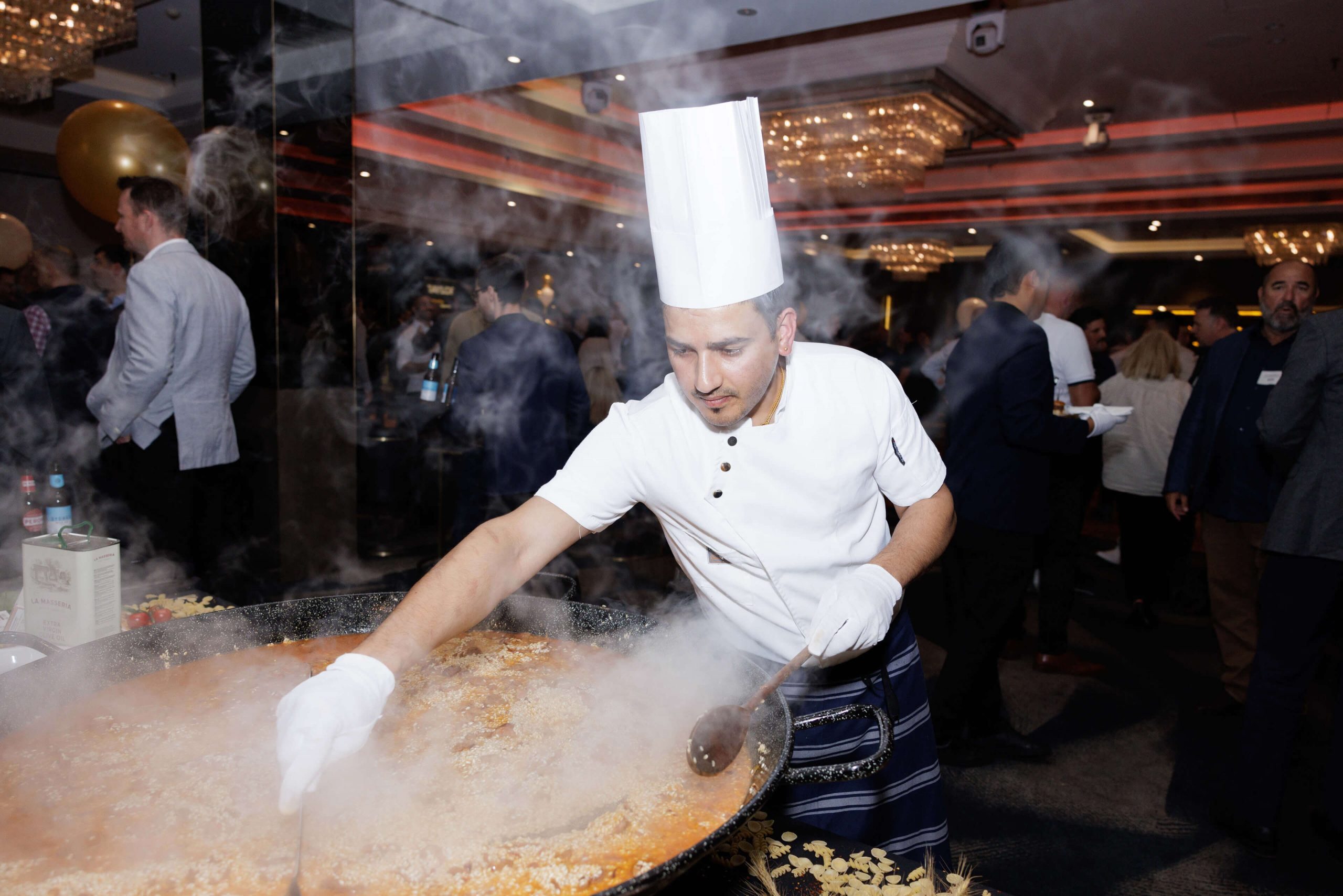 005 chef cooks fresh paella at subcontractor delivery party taylor