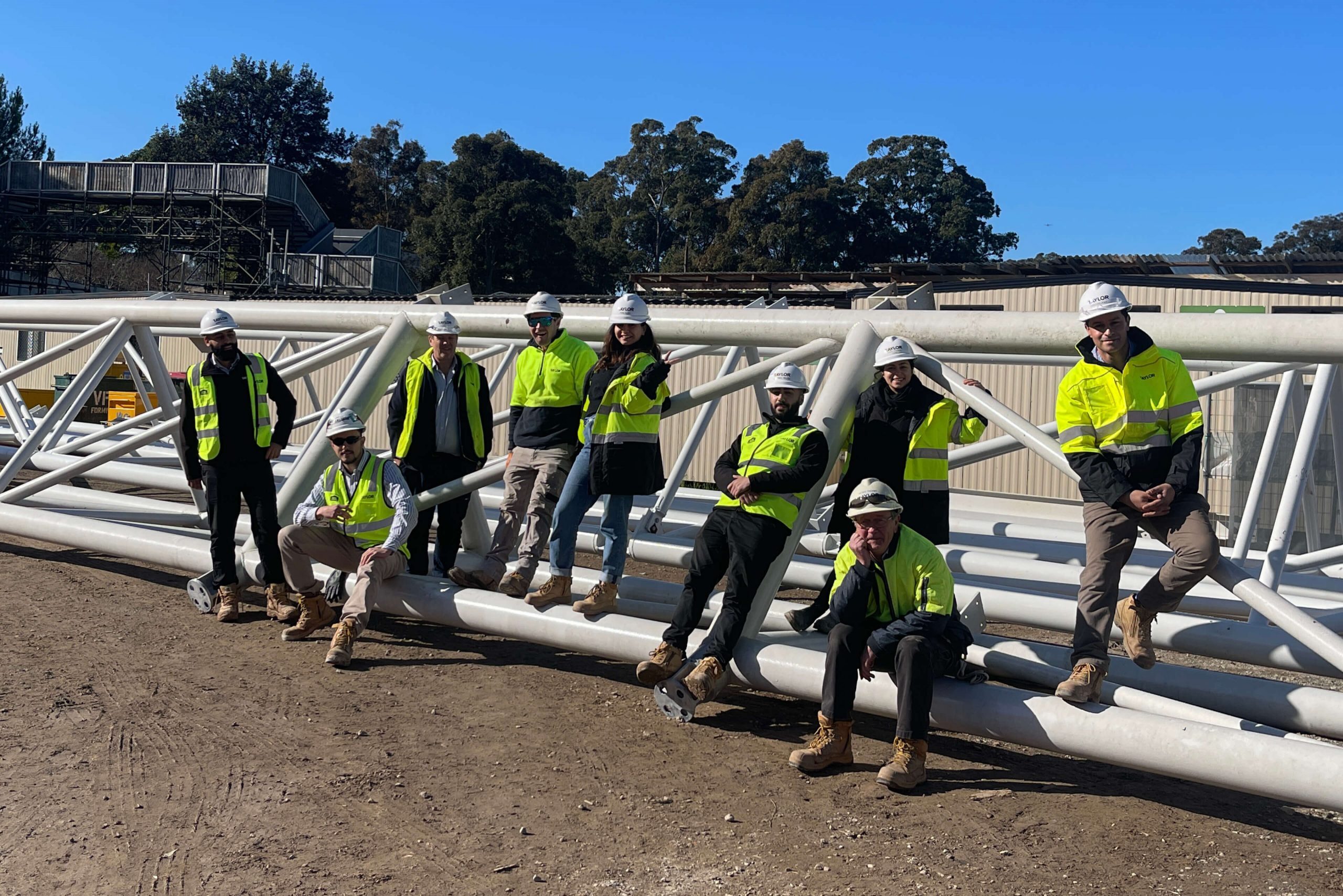 006 the taylor team smiling onsite against materials