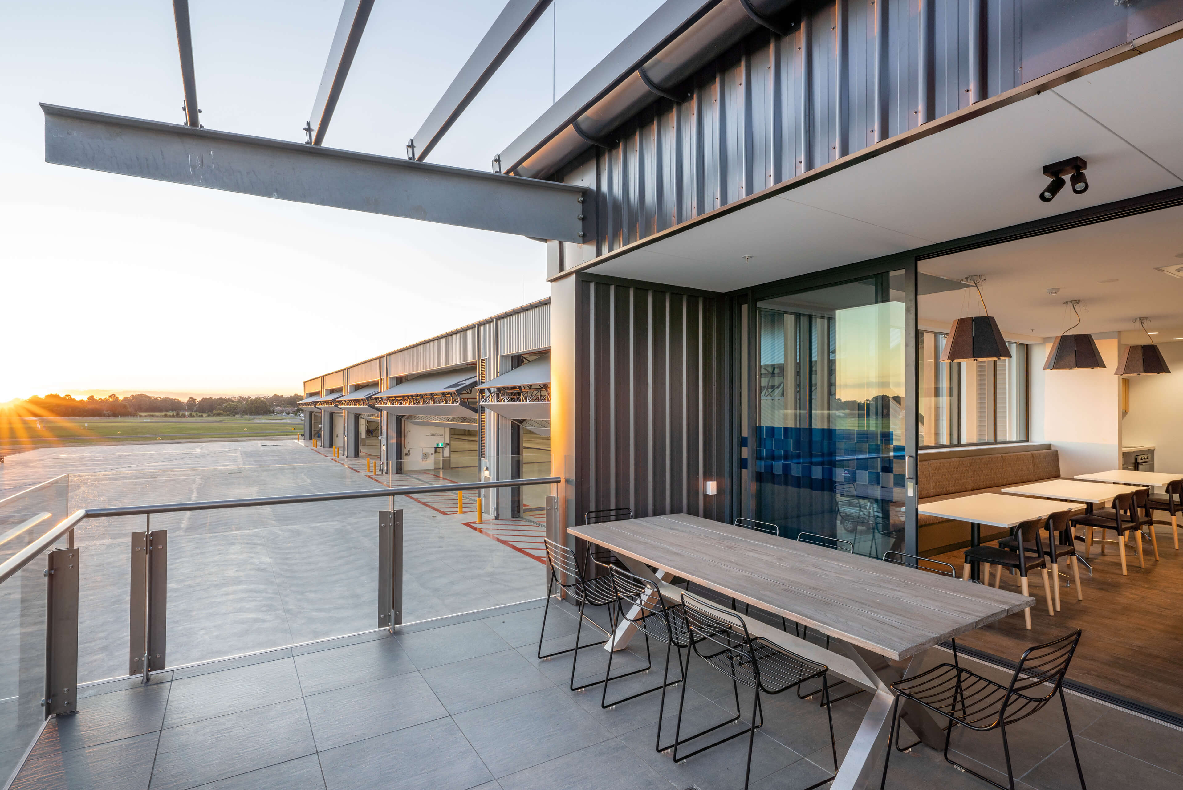 23 looking out over hangar bars from balcony at sunset at polair facility bankstown taylor construction refurbishment and live environments