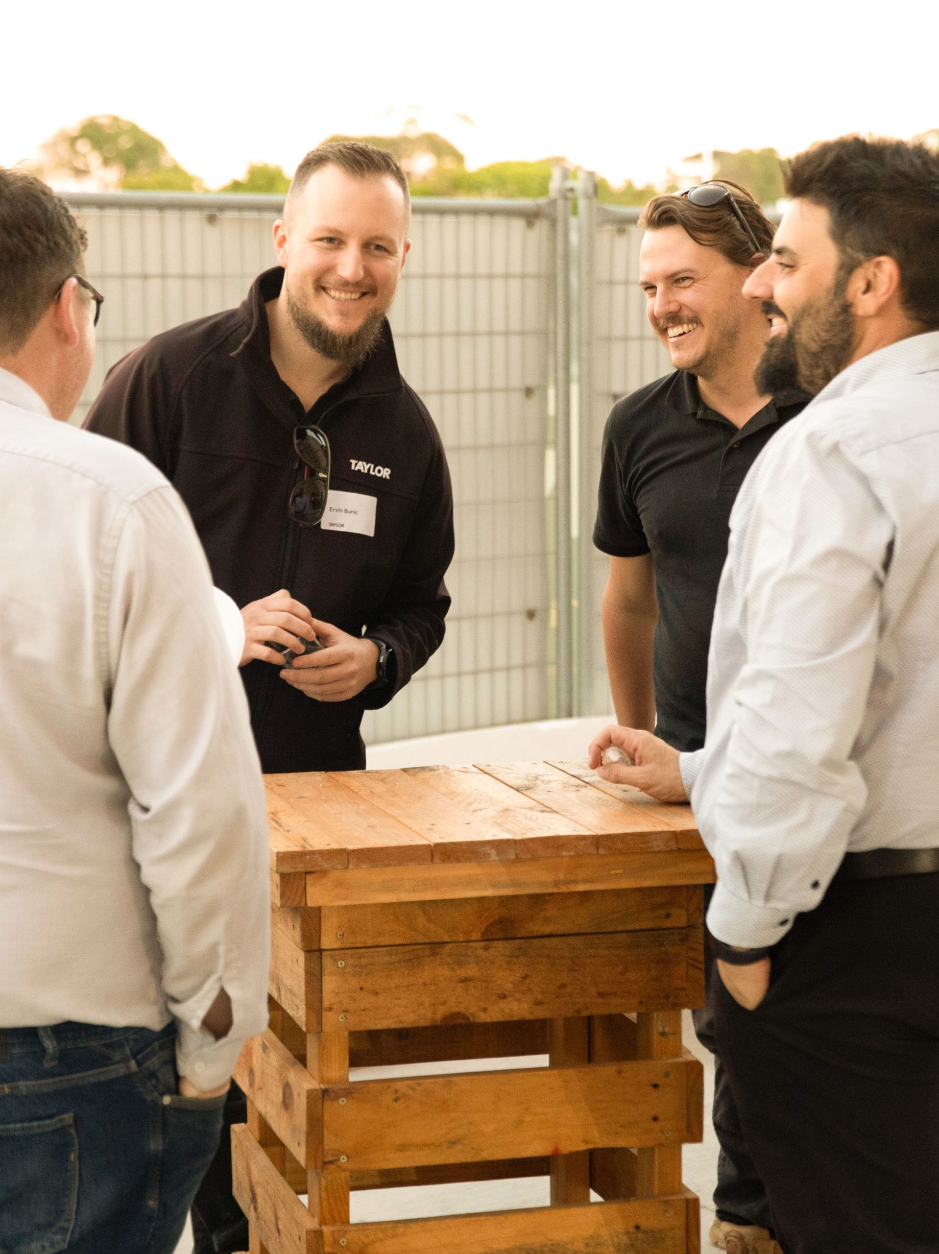 3 men laughing lets get together the scot college taylor construction culture