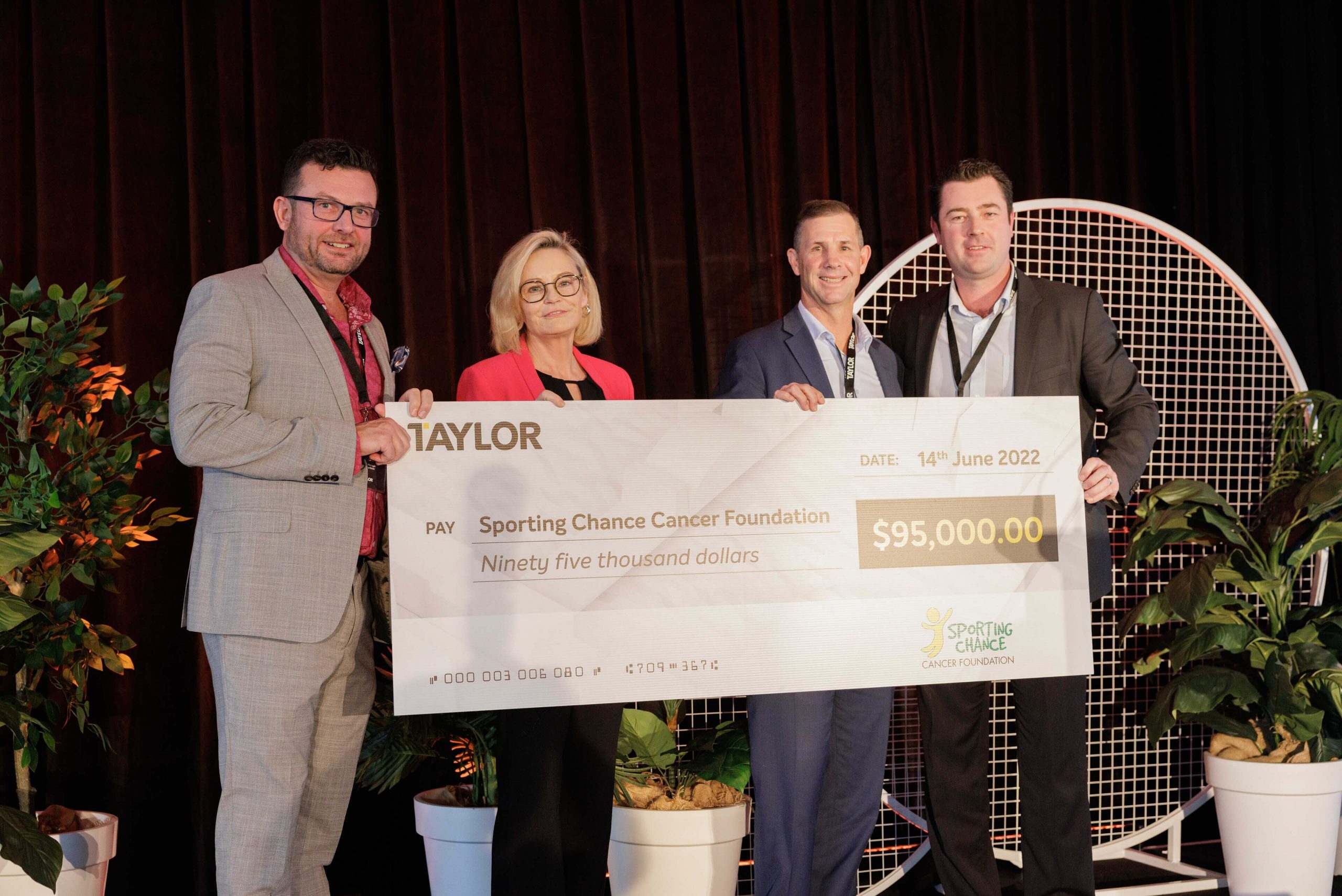 39 annual staff conference taylor presenting cheque sporting chance foundation