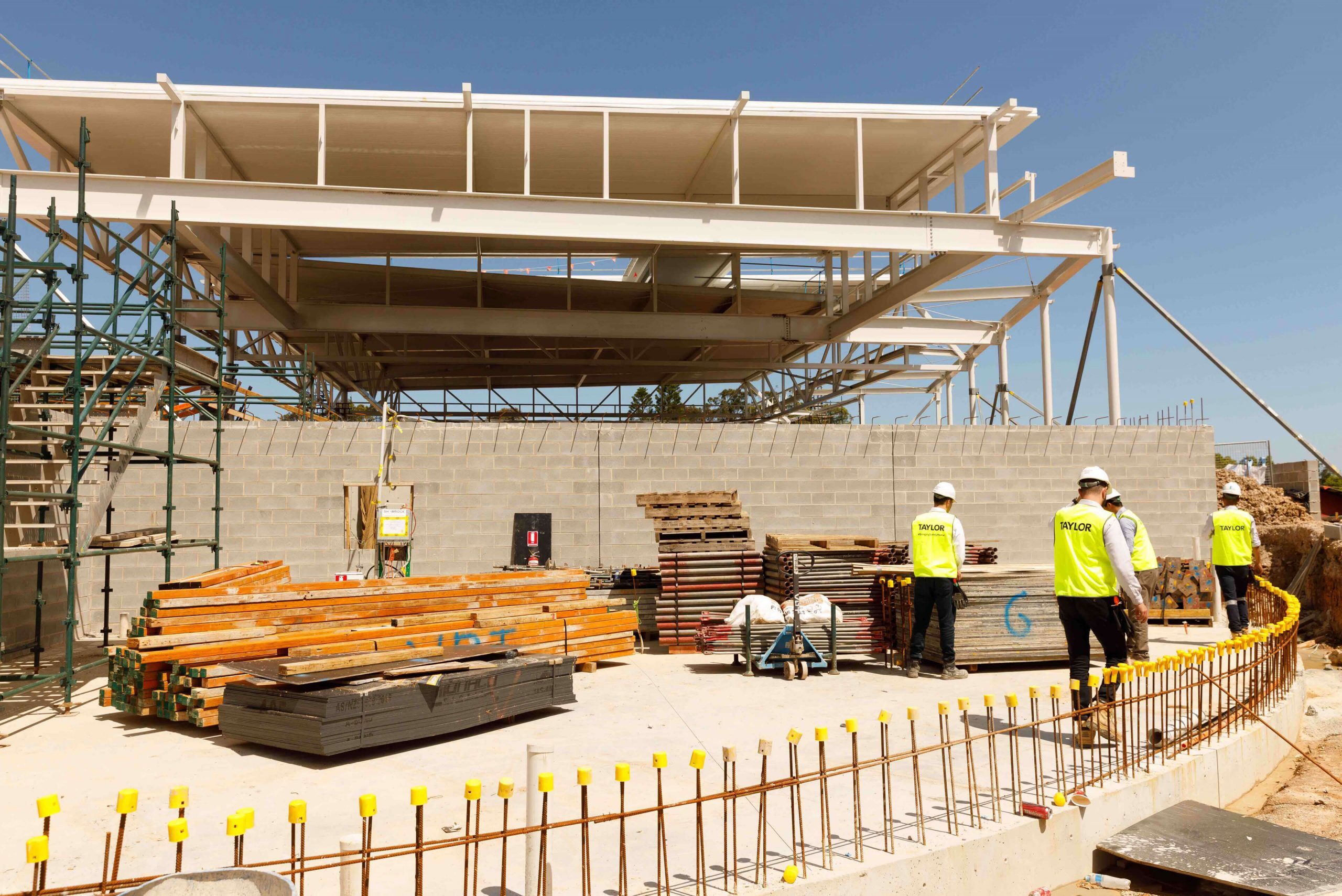 6 four staff moving around site tara aquatic centre taylor construction refrubishment and live environments
